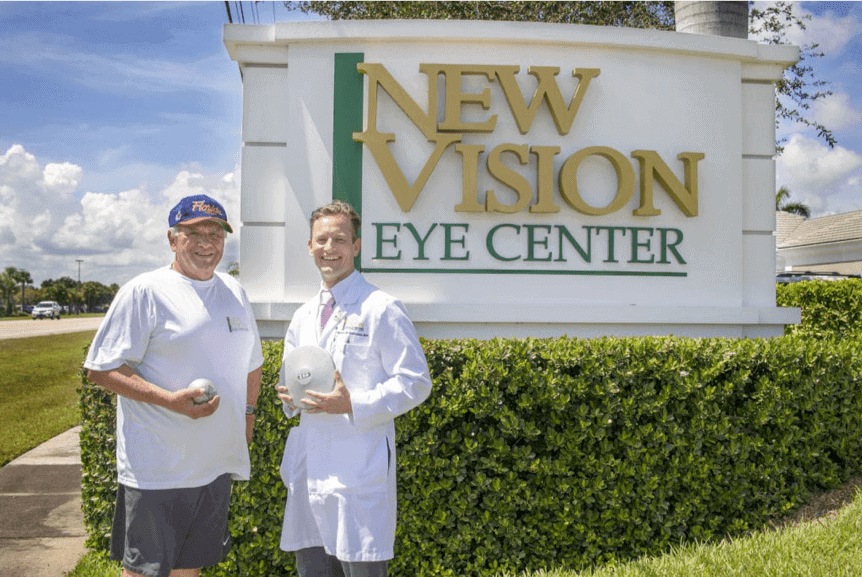 Dr. Robert M. Reinauer in front of New Vision Eye Center Sign