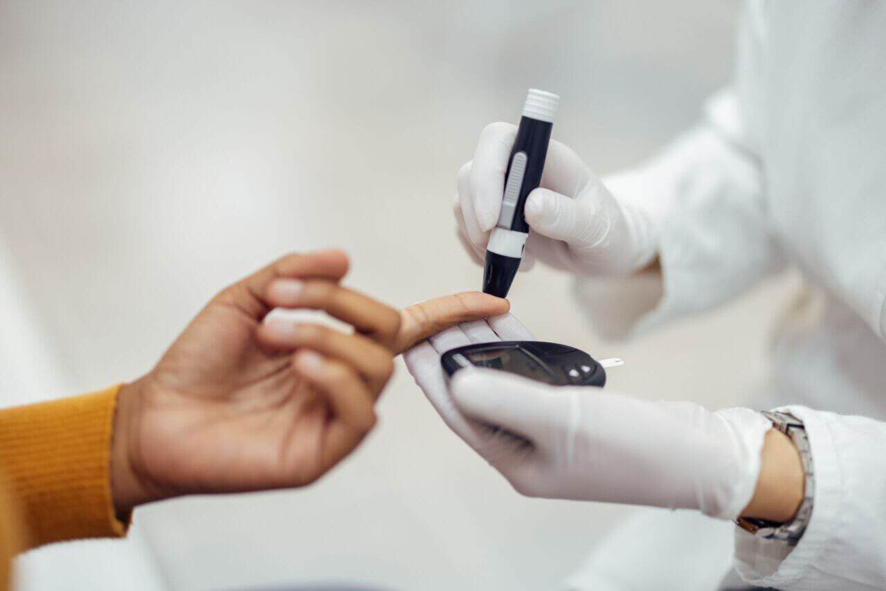 person getting their blood glucose checked